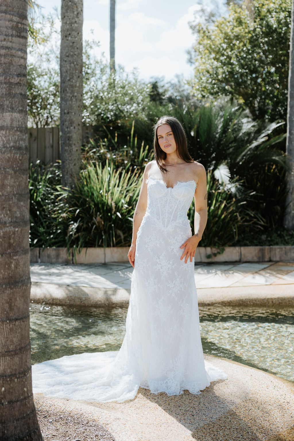 Chiara designer French lace wedding gown with fitted corset bodice and elegant train