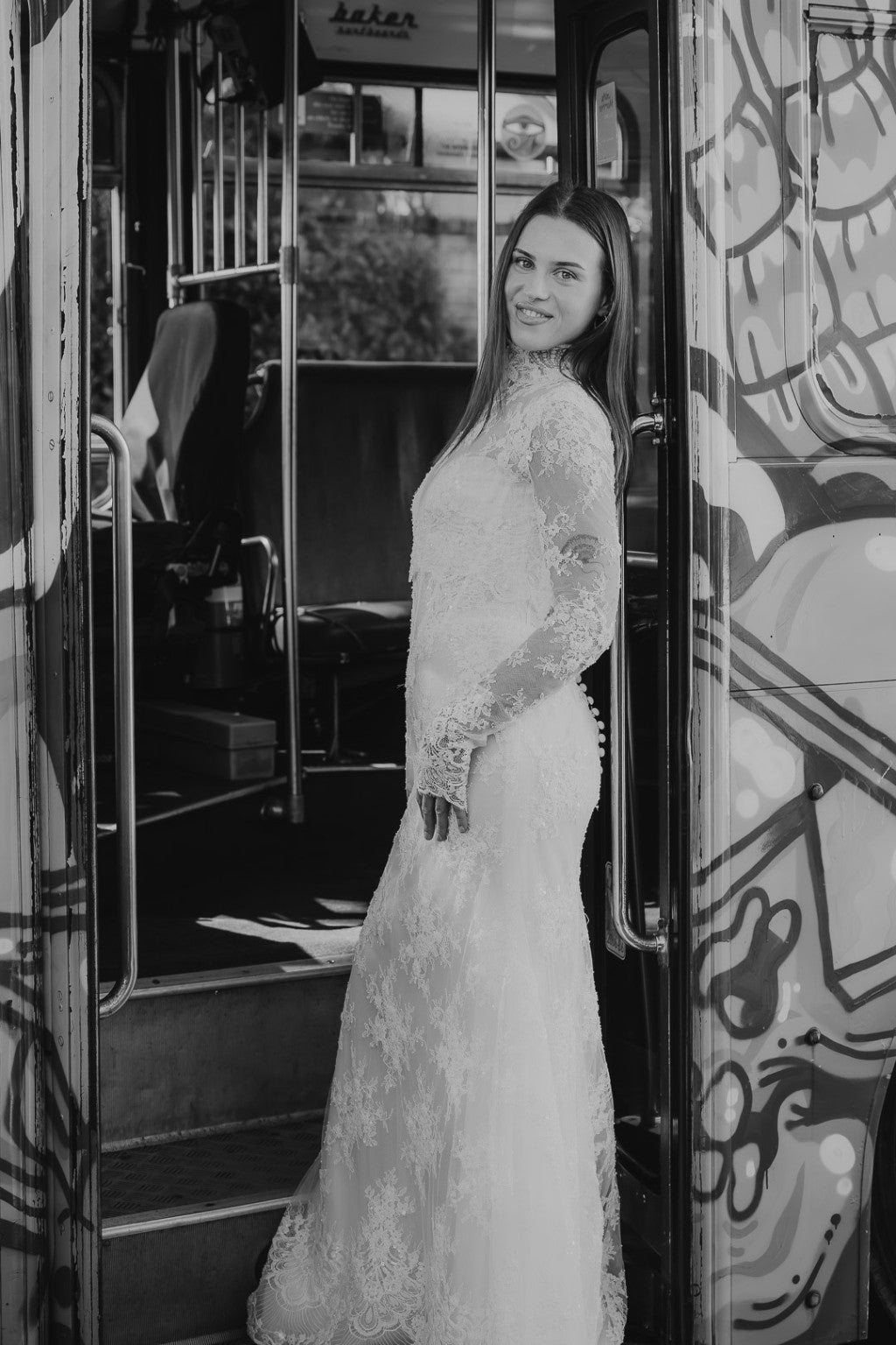 Chiara French lace wedding gown with optional lace bolero in black-and-white bus portrait