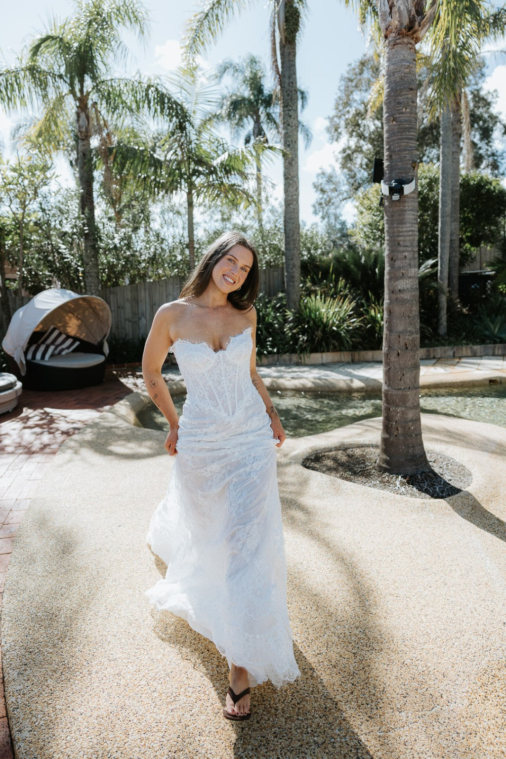 Bride wearing Chiara French lace fitted wedding gown standing outdoors