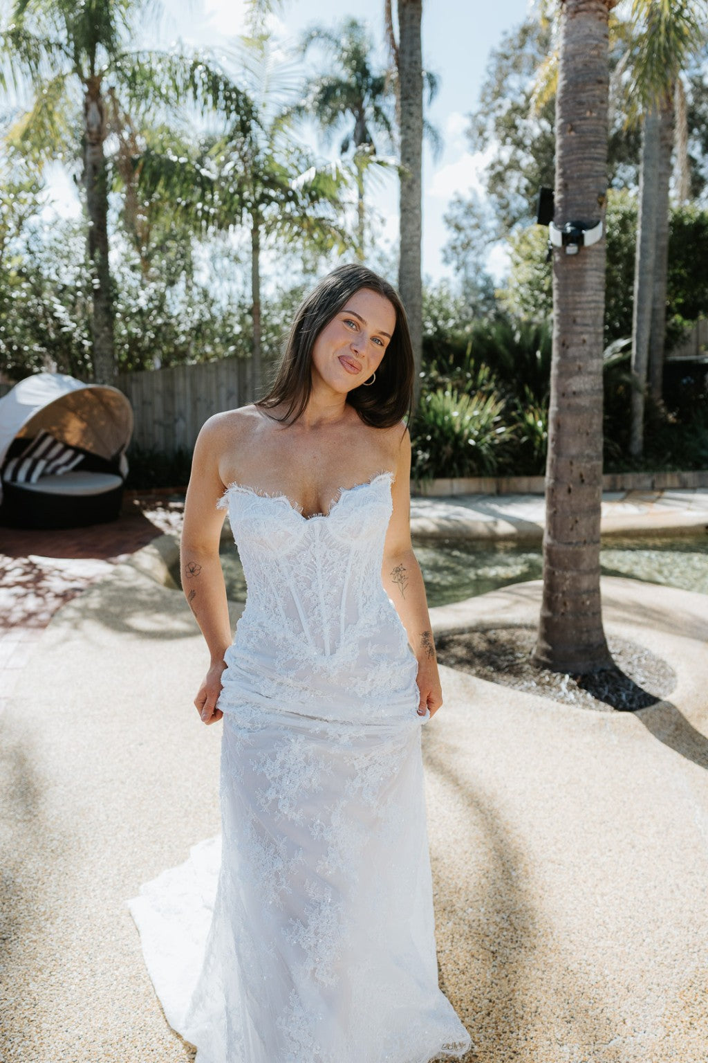 Chiara French lace wedding dress with figure-skimming skirt and sweetheart corset by the pool