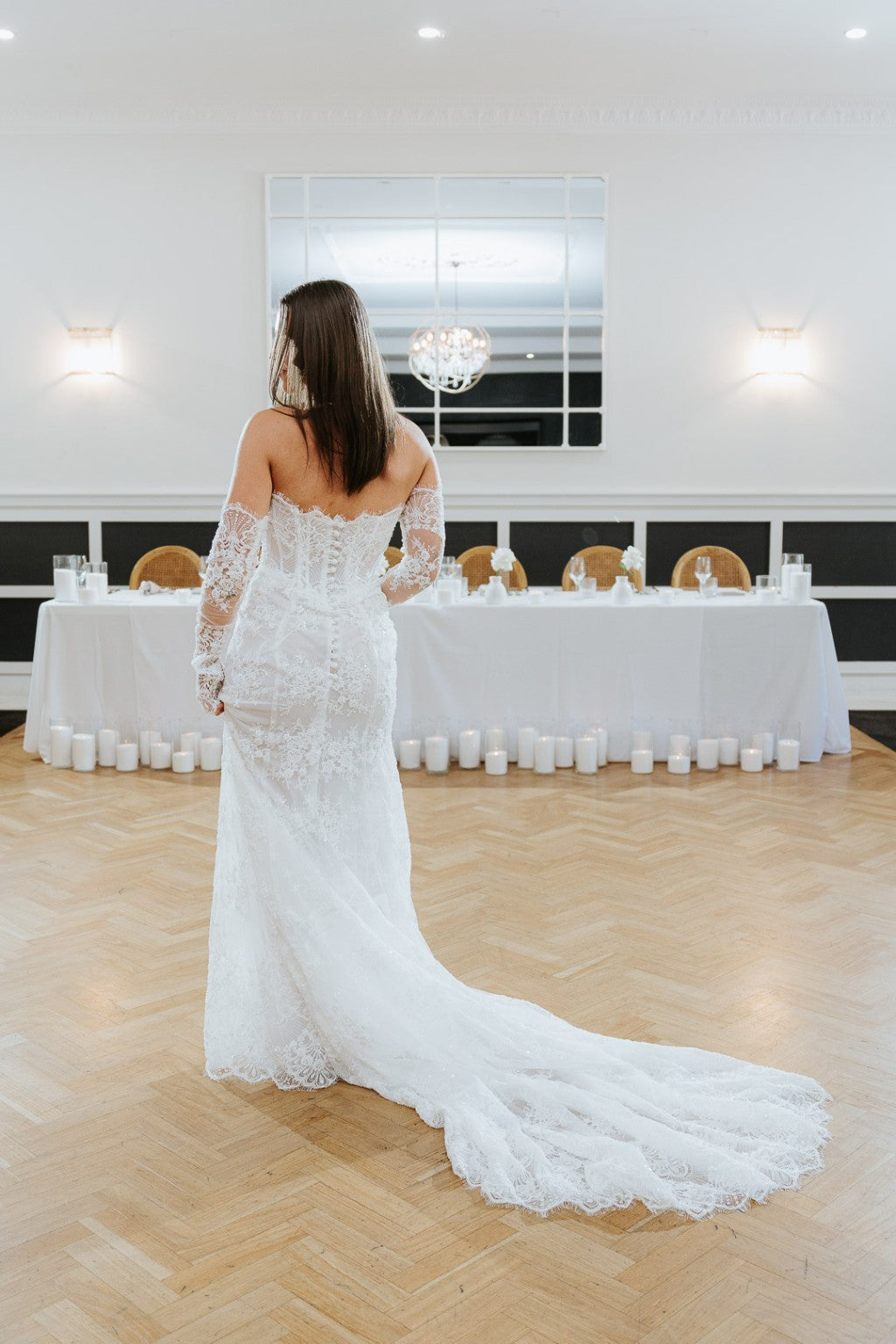 Back of Chiara French lace wedding dress with structured corset and long lace train