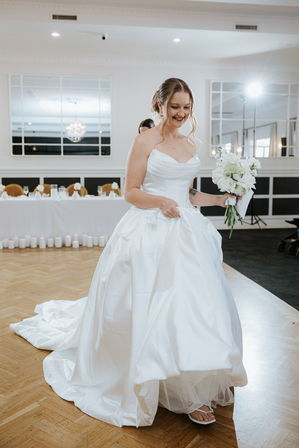 Bride in Serafina duchess satin bridal gown at reception